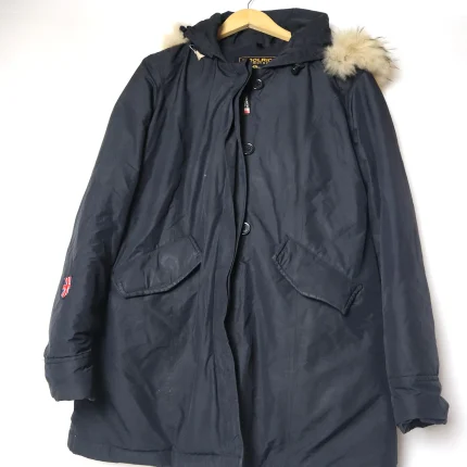 Stay warm and stylish in this Woolrich vintage down jacket. This black hooded parka is made of goose down feathers and has a quilted lining for extra comfort. It features a zip and snap closure, two front pockets, and a detachable fur trim. This is a rare and authentic Woolrich original from the 1980s, in excellent condition and ready to ship. Size M, fits true to size.
