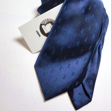 Yves Saint Laurent, YSL, vintage tie, designer tie, polyester tie, royal blue tie, men's fashion, formal wear, business attire, collector's item, jacquard weave, logo motif.