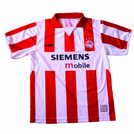 Relive the glory days of Greek football with this iconic Olympiakos home jersey from the 2004 season. Crafted by legendary sportswear brand Umbro, this vintage gem captures a pivotal moment in the club's storied history.