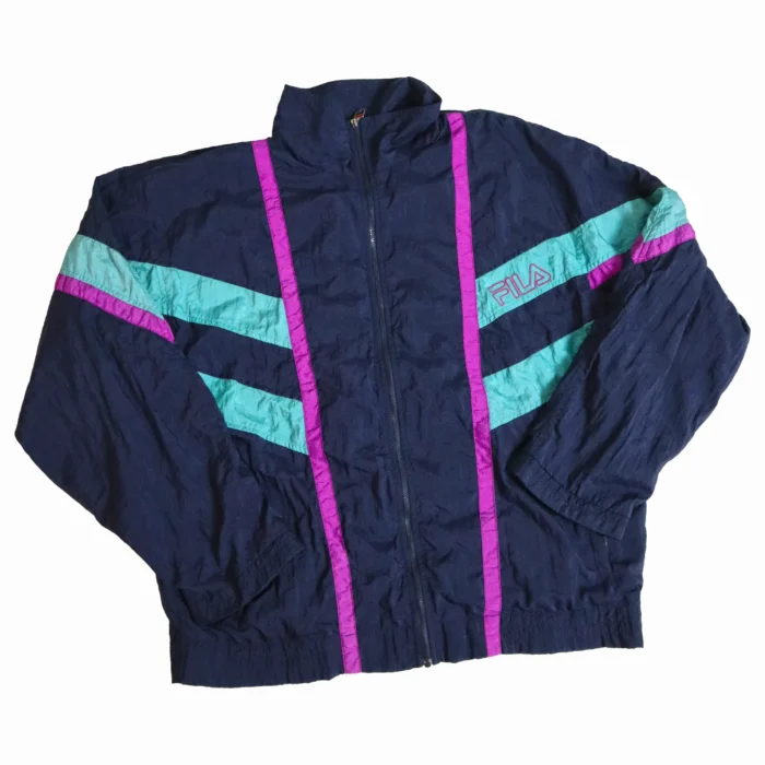 Step back in time with this classic 90s FILA windbreaker. Featuring a bold navy base with eye-catching teal and magenta color blocking, this jacket embodies the vibrant style of the era. The full-zip front and high collar offer versatile wear, while the lightweight fabric provides perfect protection for breezy days.